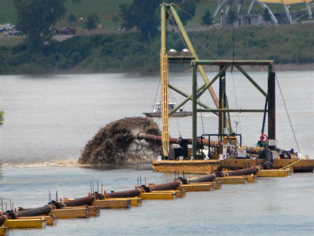 Dredged material deposited along a riverbank as part of an erosion control effort