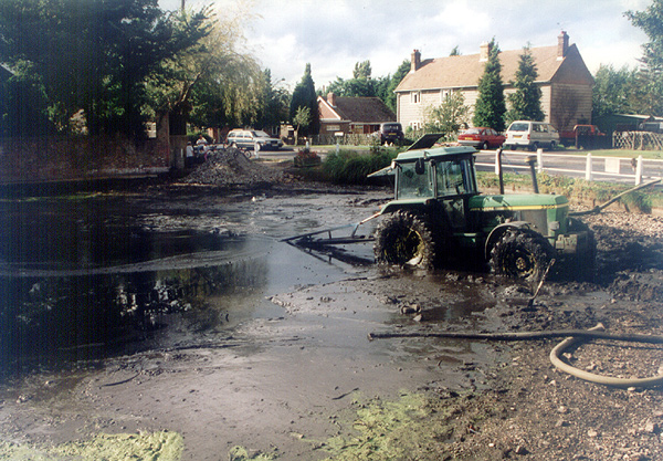 A pond during vegetation and muck management dredging work